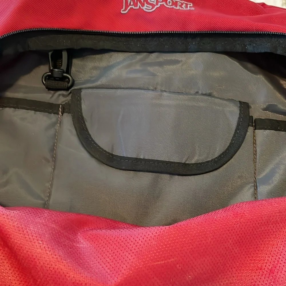 Red Jansport laptop messenger bag. Interior Velcro & outer zippered compartment